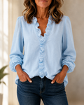 Blusa azul celeste con volantes y botones